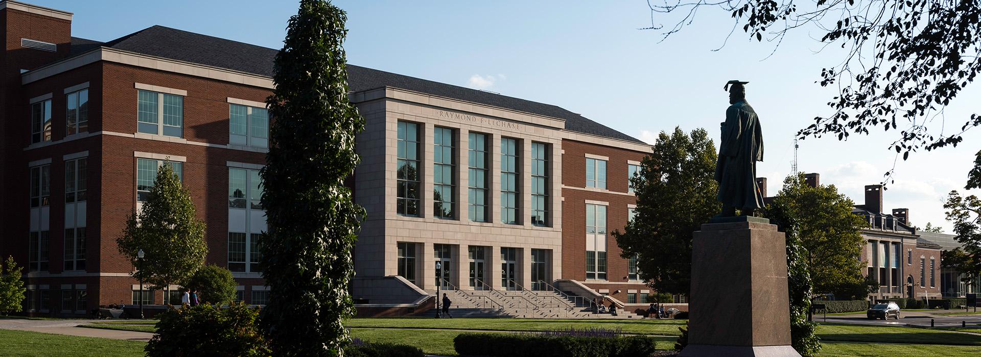 The Warner School's LeChase Hall, photographed on a sunny day as students pass by. 