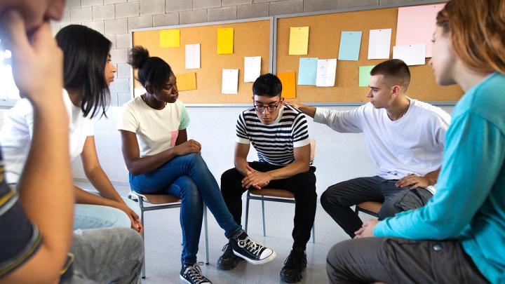 School-age students sitting in a grief circle