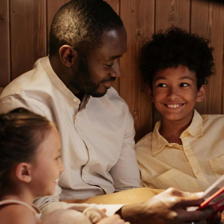 Male Adult reading to two kids